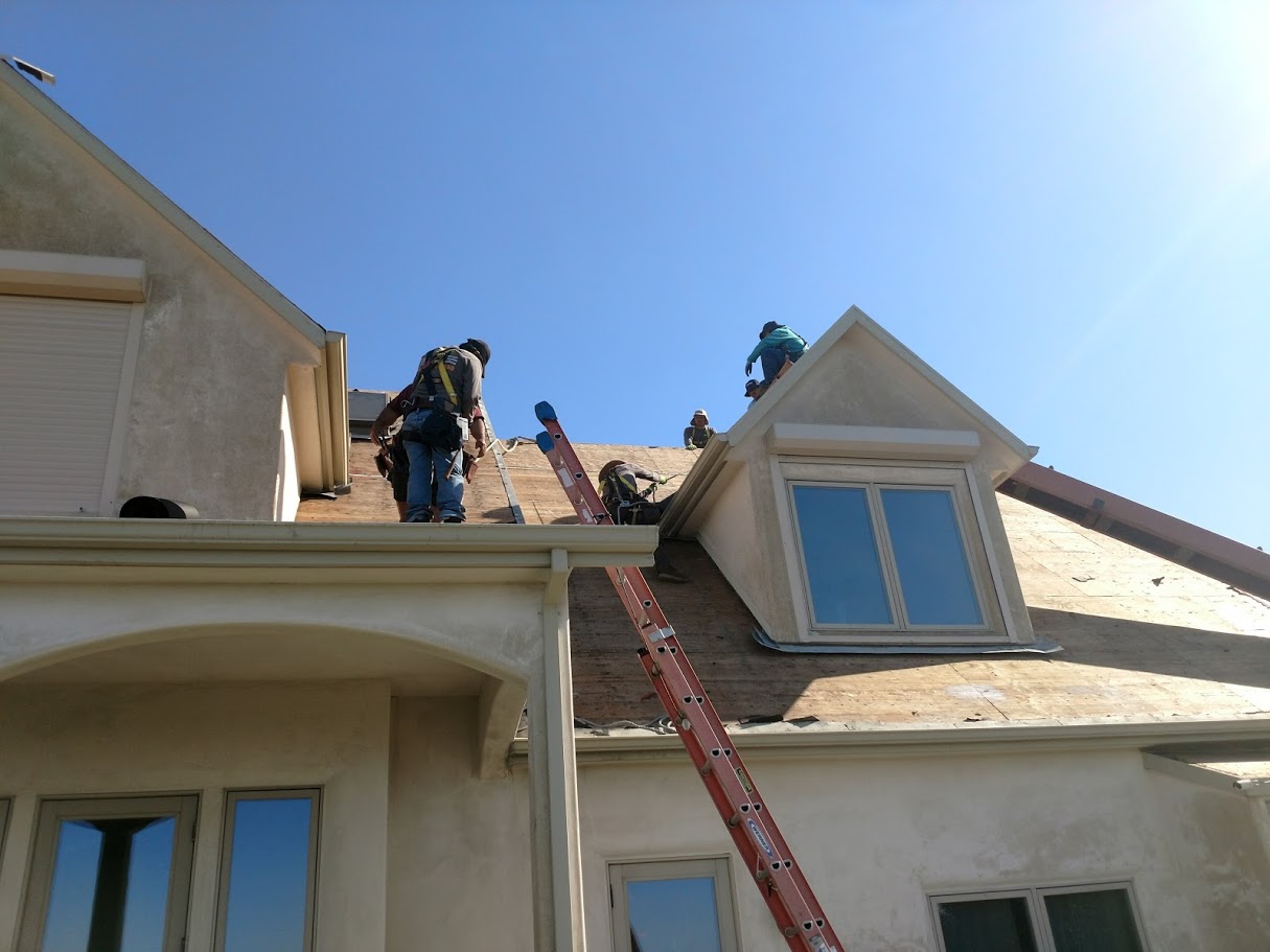 Workers installing roof